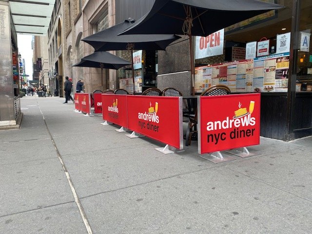 Full fabric panel restaurant sidewalk barrier with printed branding