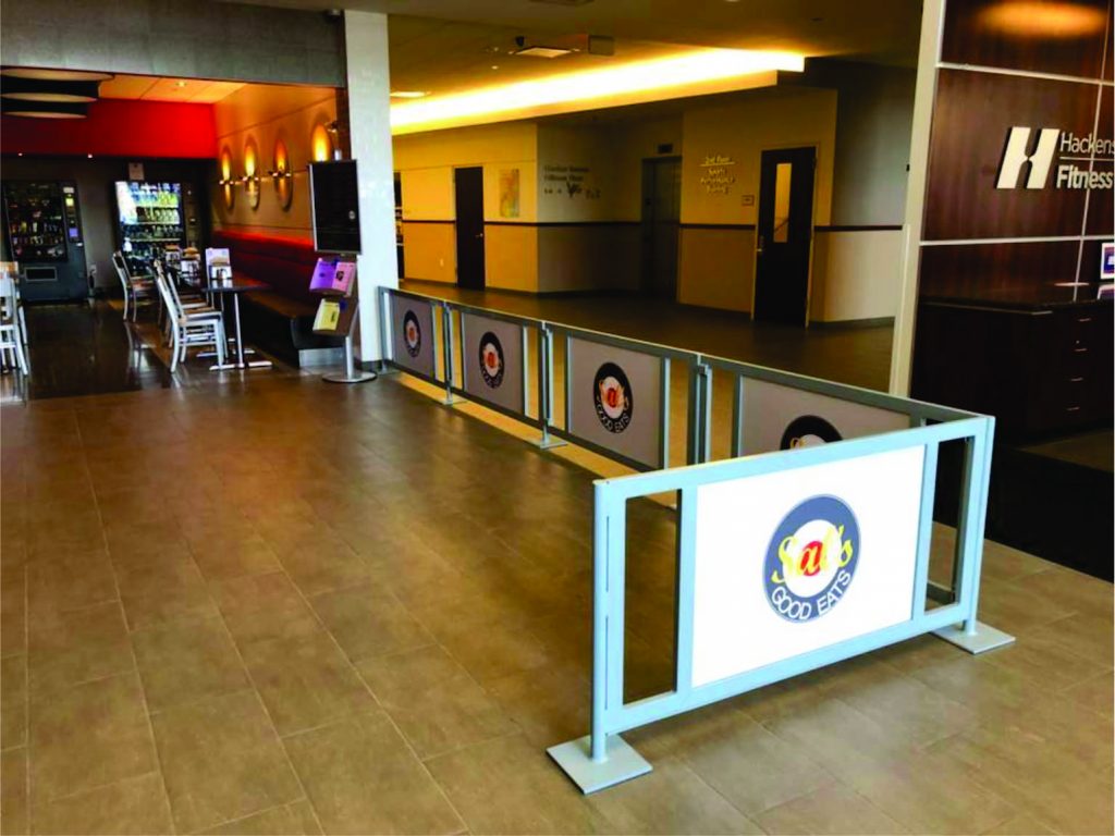 Open rail barrier with centered branded solid panels